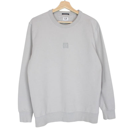 CP Company grey cotton sweatshirt with logo patch and ribbed cuffs.