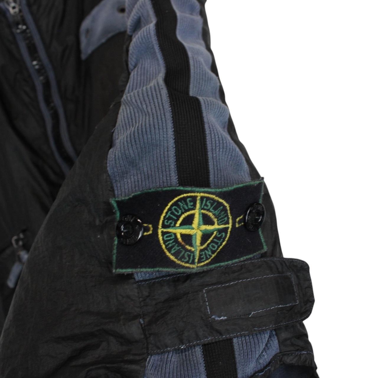 Stone Island navy blue reversible vest with green edge and logo patch detail.