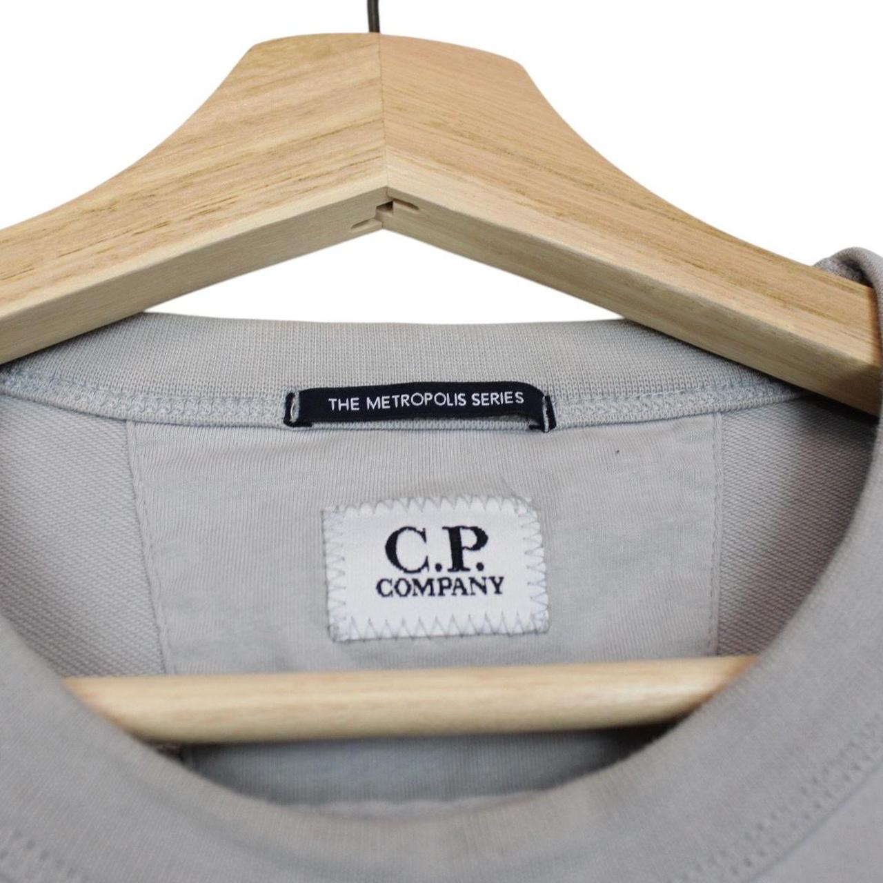 CP Company grey cotton sweatshirt with logo patch and ribbed cuffs.