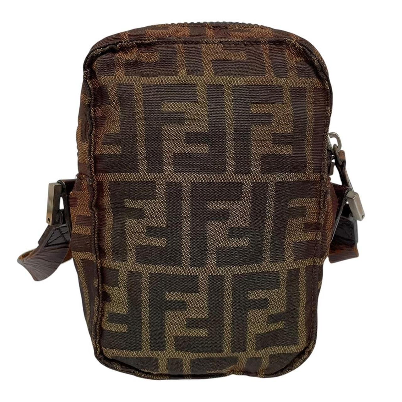 Fendi brown duffel bag with monogram canvas, visible wear and cracking on strap.