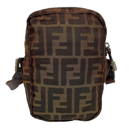 Fendi brown duffel bag with monogram canvas, visible wear and cracking on strap.