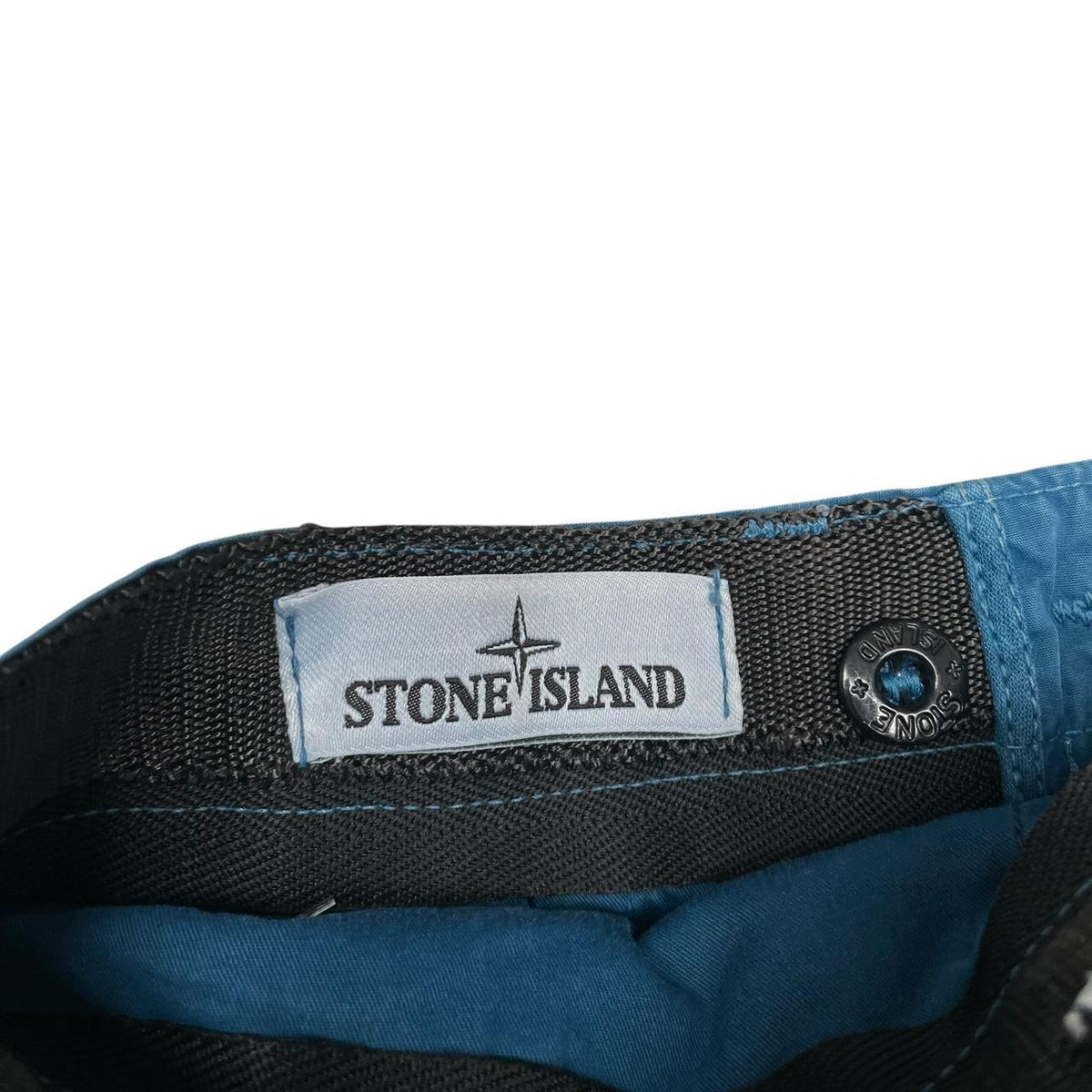 Stone Island teal blue cargo shorts with logo patch and cotton material.