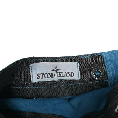Stone Island teal blue cargo shorts with logo patch and cotton material.