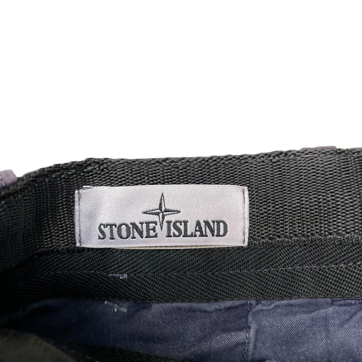 Stone Island navy blue Bermuda shorts with logo patch and cotton material.