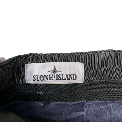 Stone Island navy blue Bermuda shorts with logo patch and cotton material.
