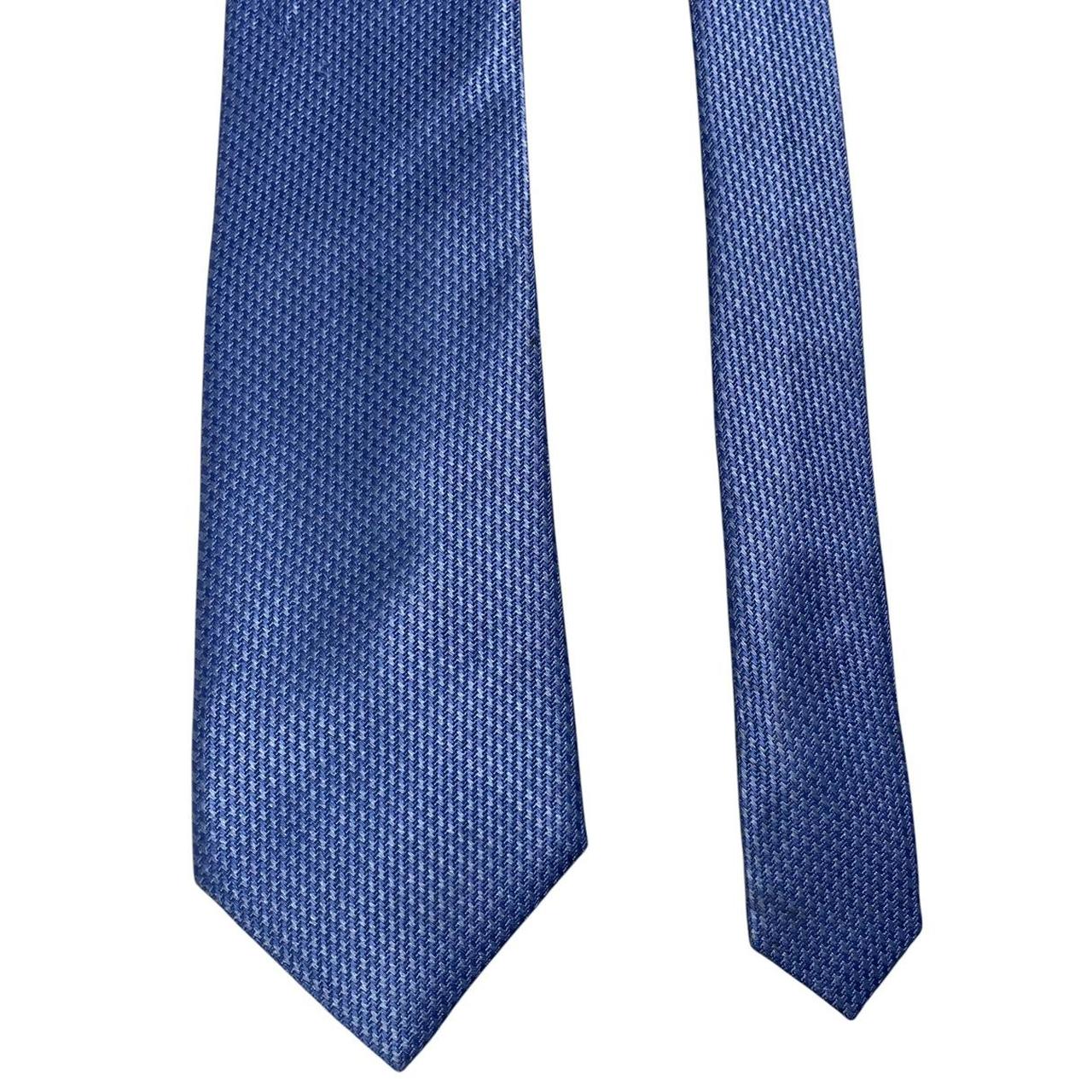 DKNY blue silk tie with subtle sheen and classic design.