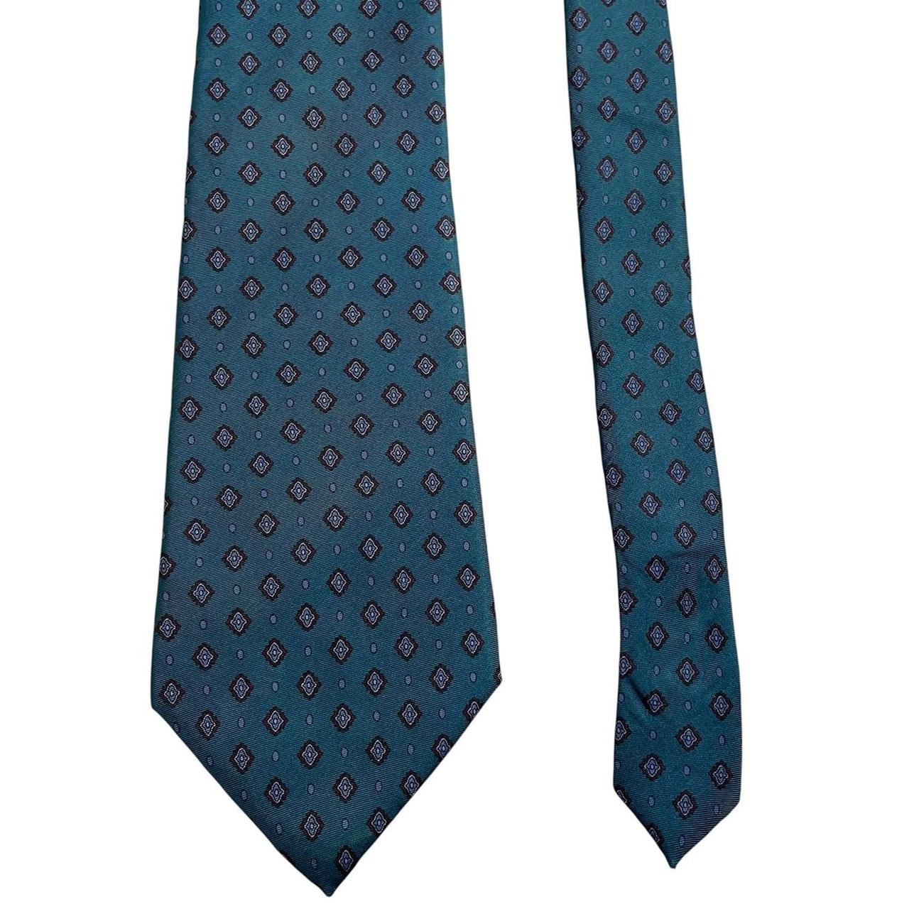 Christian Dior blue silk tie with subtle sheen and classic design.