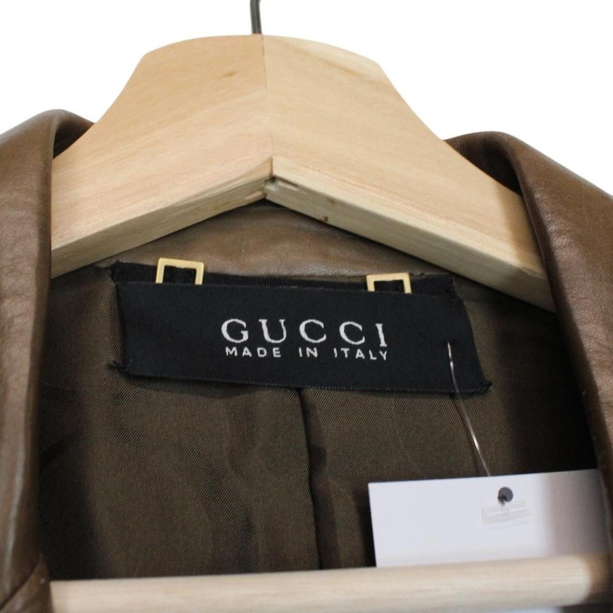 Gucci brown leather blazer jacket with logo detailing and classic tailored fit.