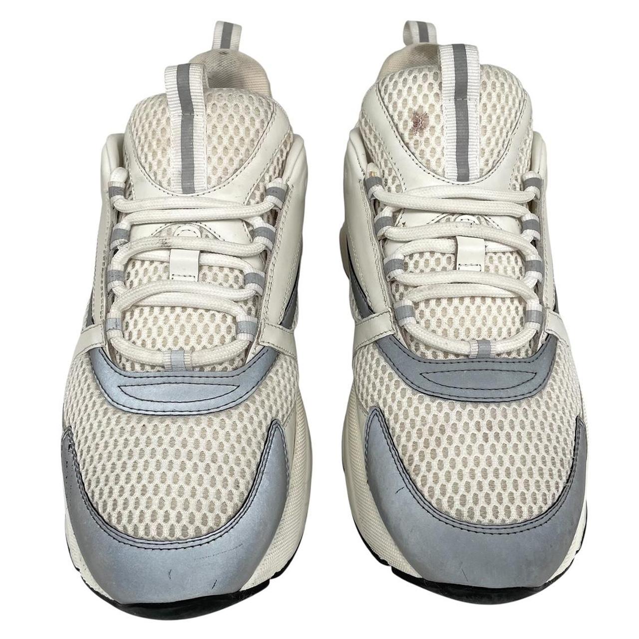 Dior grey and white trainers with logo detailing and worn soles.