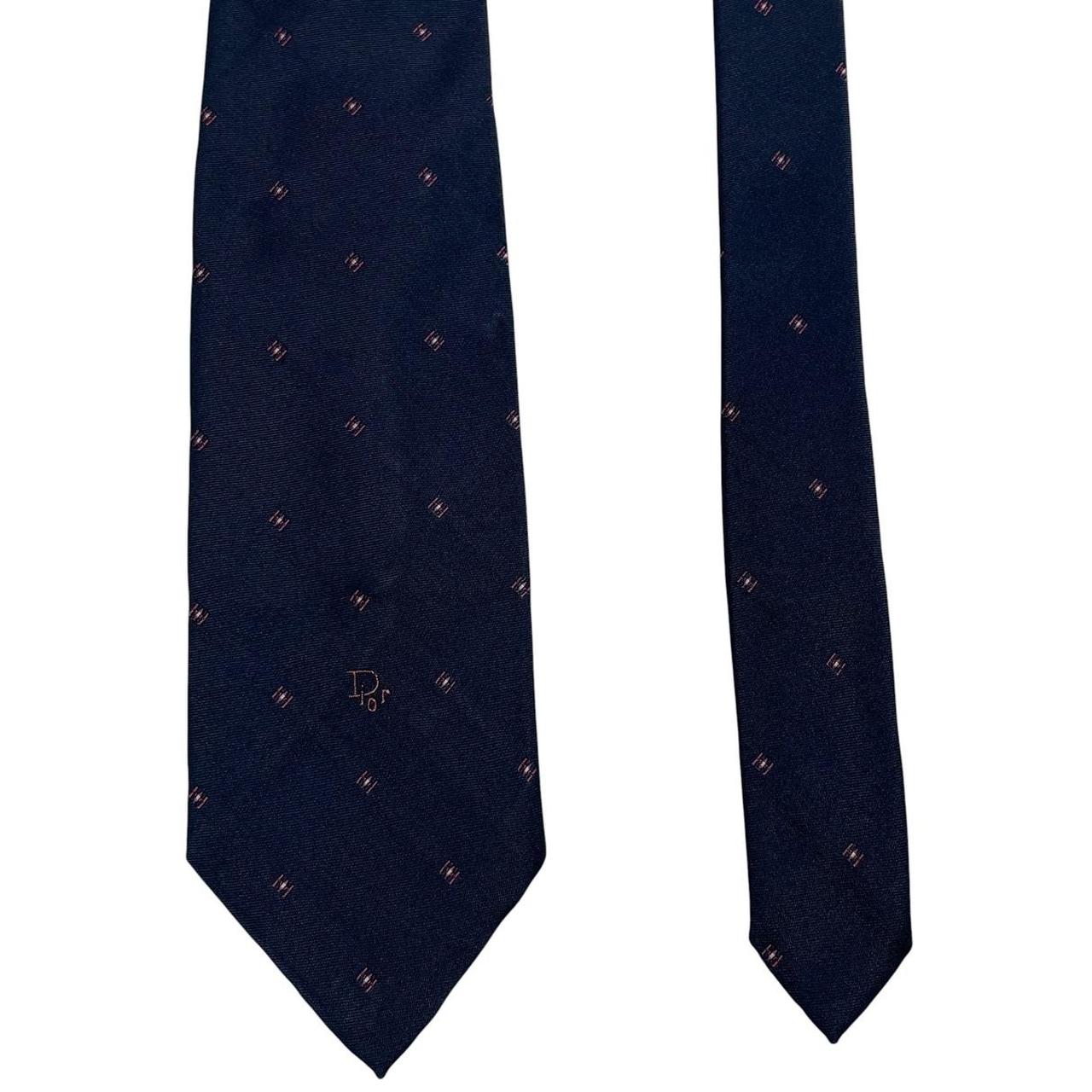 Christian Dior navy blue tie with silk blend, featuring subtle sheen and classic design.