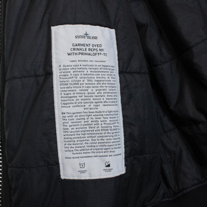 Stone Island black jacket with crinkle texture and logo patch on sleeve.