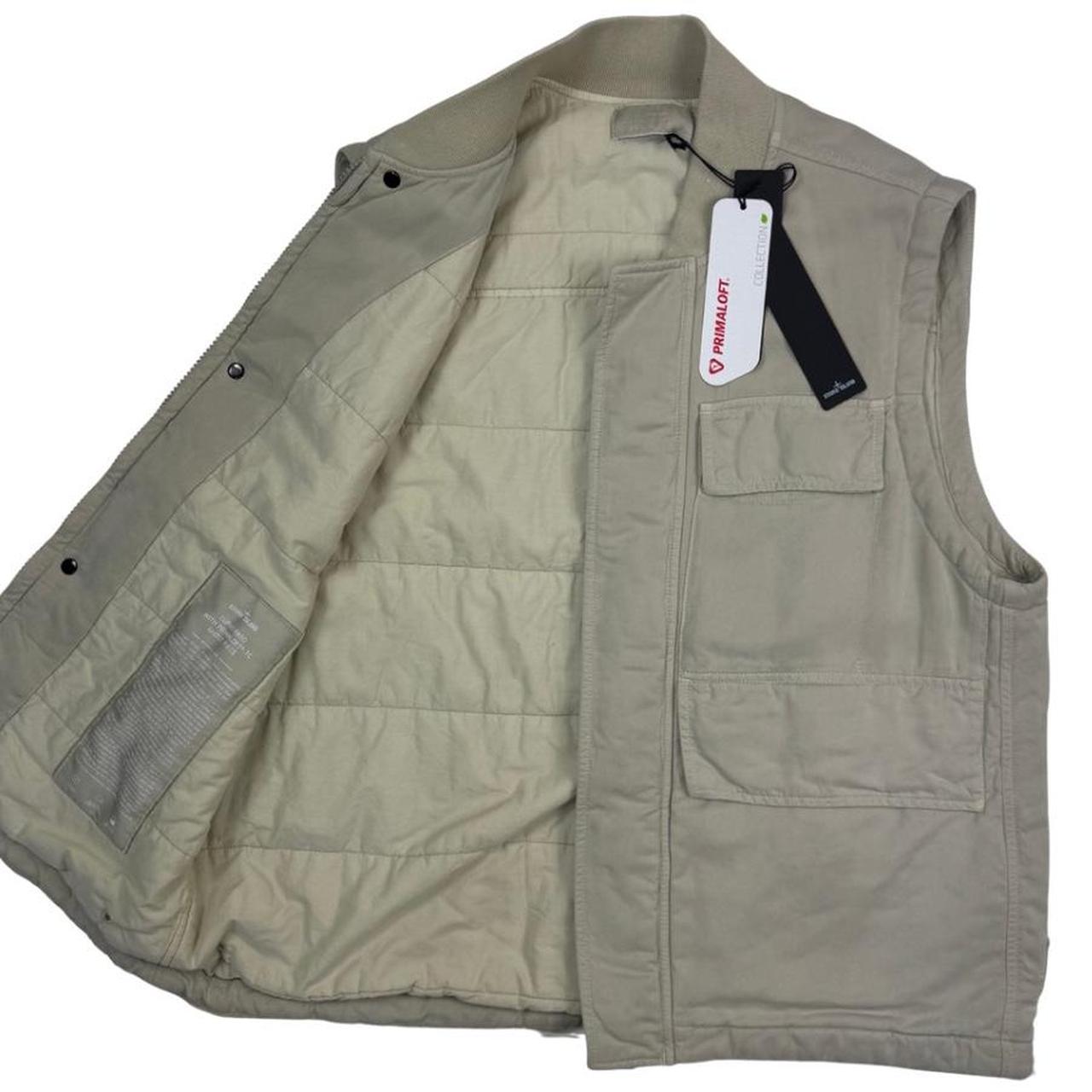 Stone Island beige vest jacket with logo patch and Primaloft material.