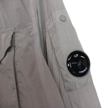 CP Company grey overshirt jacket with lens detail and garment dyed nylon fabric.
