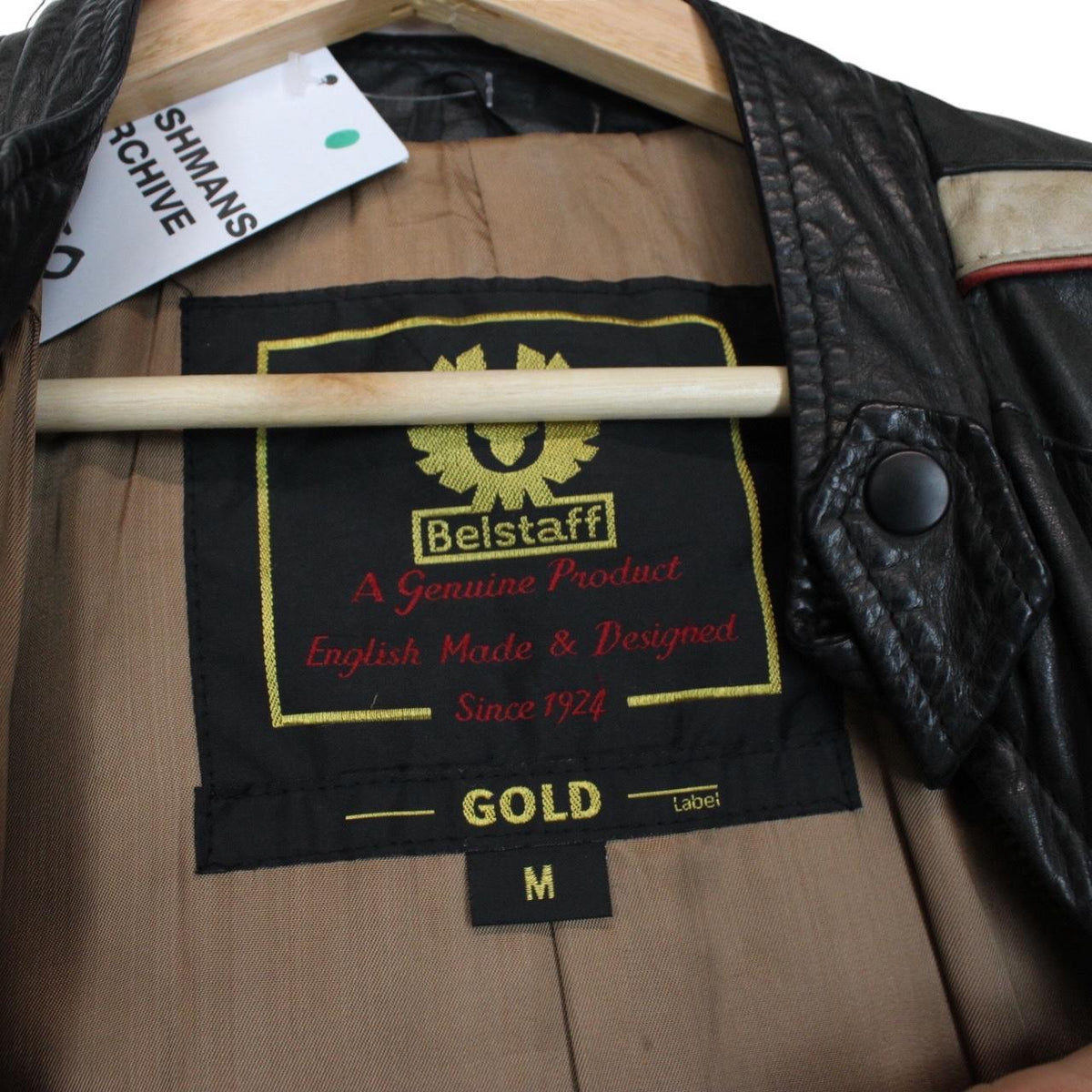 Belstaff beige and black leather jacket with vintage logo and cream detailing.