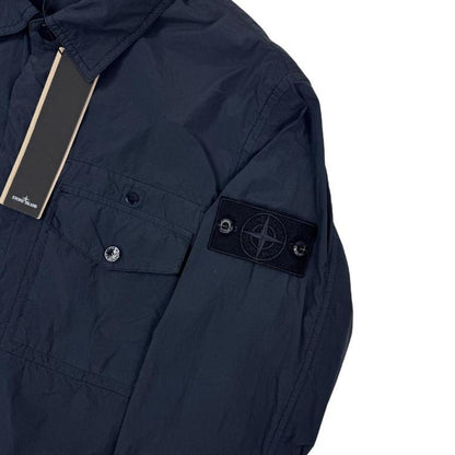 Stone Island navy blue nylon overshirt jacket with ghost logo and smooth texture.