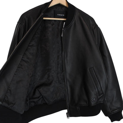Coach black lamb leather bomber jacket with full zip and brand logo.