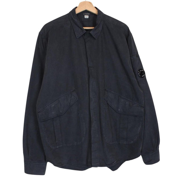 CP Company navy blue overshirt jacket with diamond pattern and lens detail.