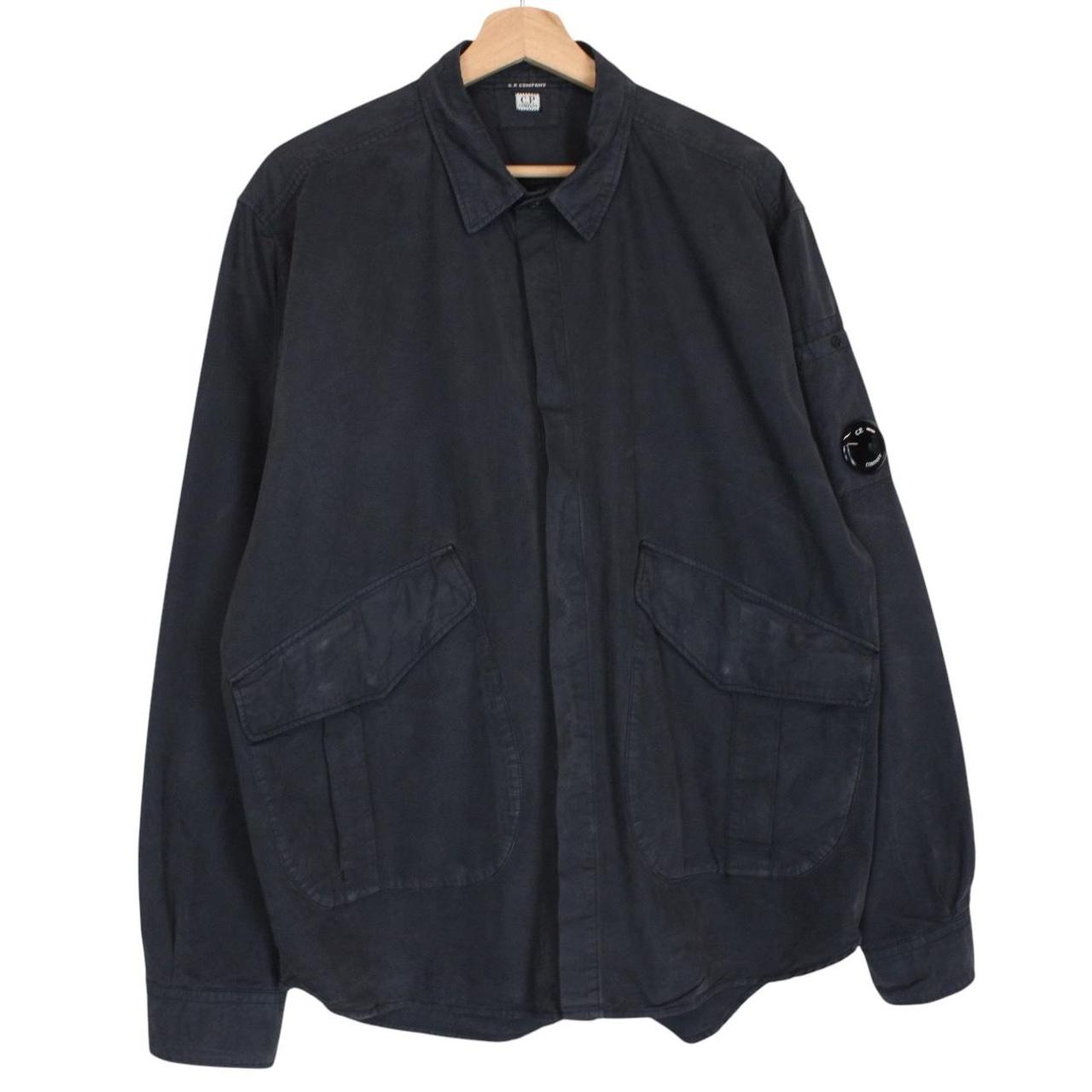CP Company navy blue overshirt jacket with diamond pattern and lens detail.