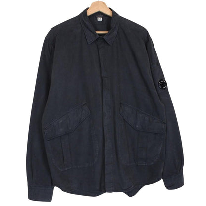 CP Company navy blue overshirt jacket with diamond pattern and lens detail.