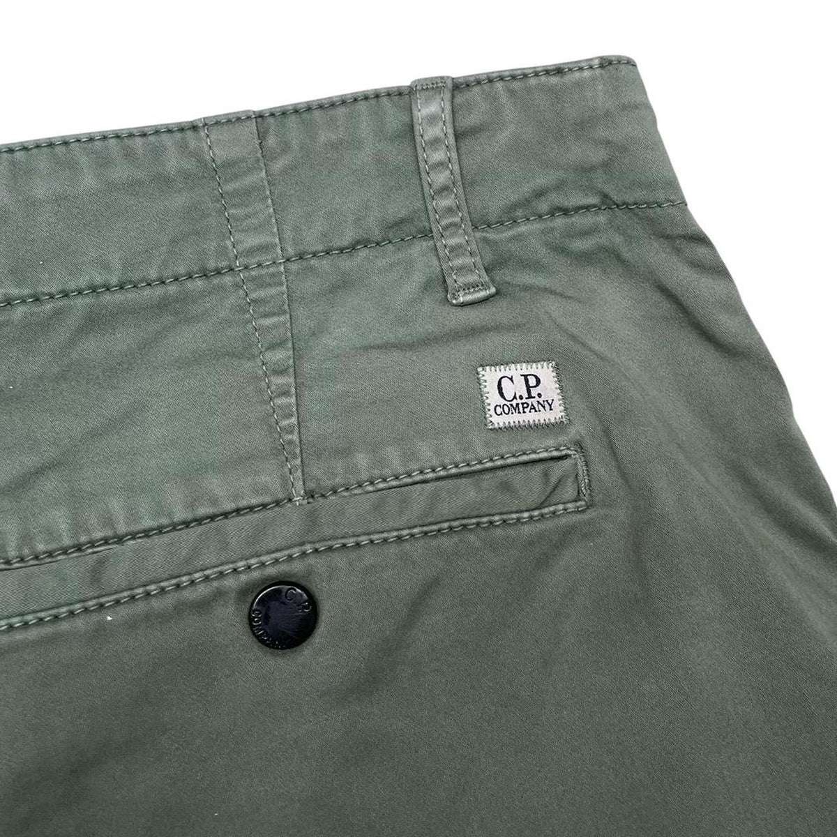 CP Company green cargo shorts with lens detail and cotton material, size XL.
