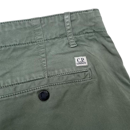 CP Company green cargo shorts with lens detail and cotton material, size XL.