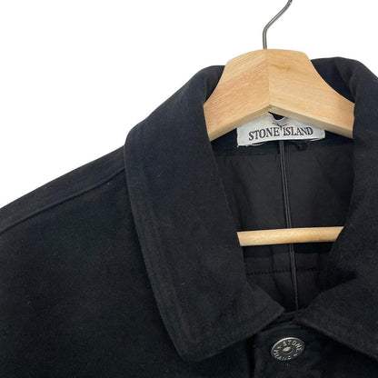 Stone Island navy blue work jacket with detachable compass badge and button-down closure.