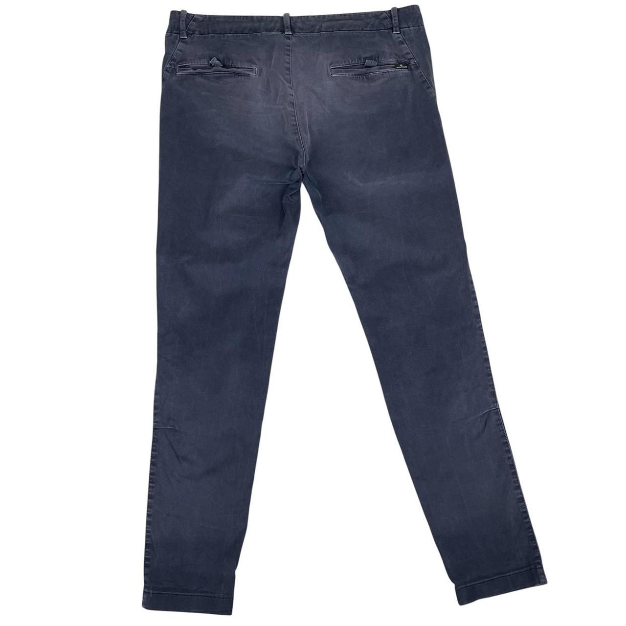 Stone Island navy blue slim fit cotton trousers with logo patch and fading details.