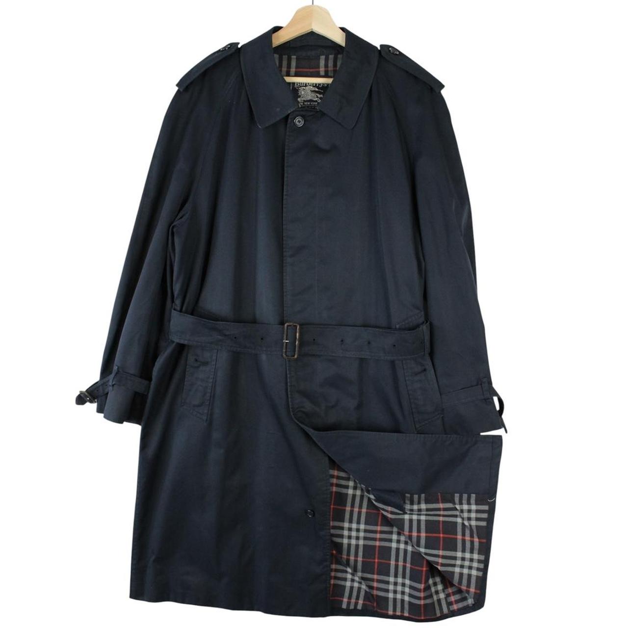 Burberry navy blue trench coat with belted waist and single breasted design.