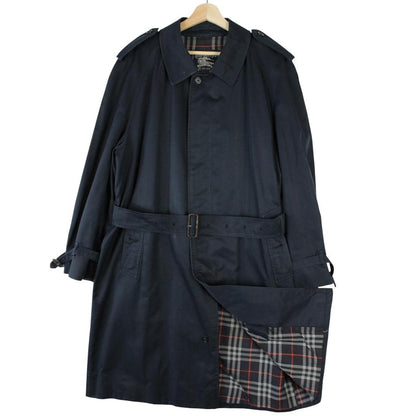 Burberry navy blue trench coat with belted waist and single breasted design.