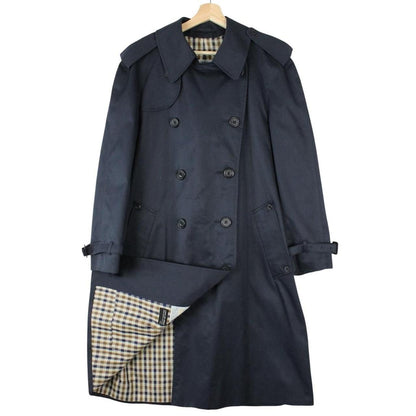 Aquascutum navy blue double breasted trench coat with house check pattern and logo.