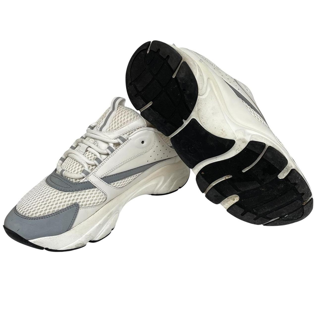 Dior grey and white trainers with logo detailing and worn soles.