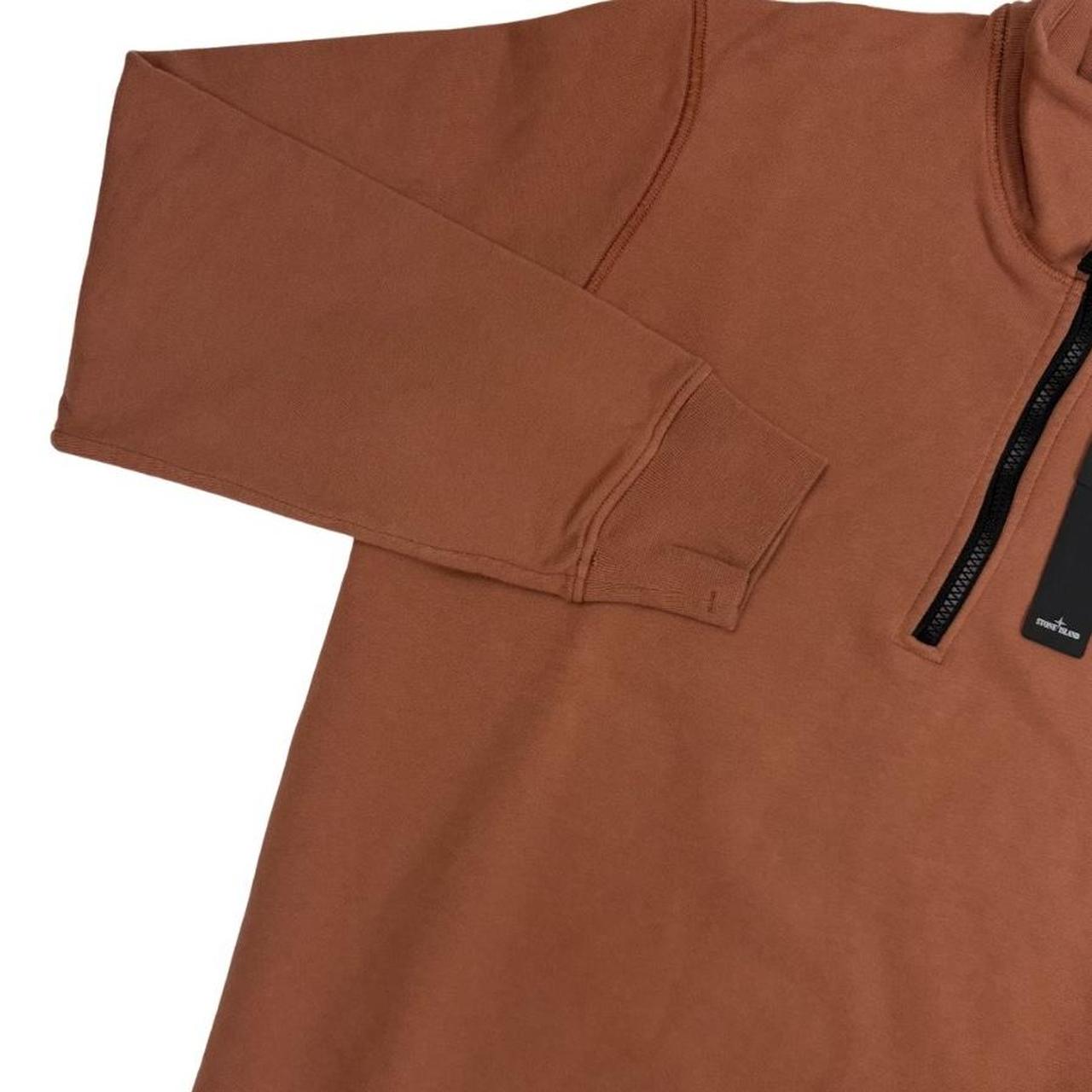 Stone Island orange jumper with 1/4 zip, logo patch on sleeve, organic cotton.