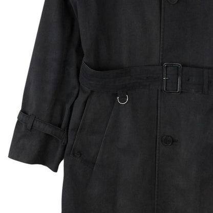 Aquascutum black trench coat with house check pattern and belted waist detail.