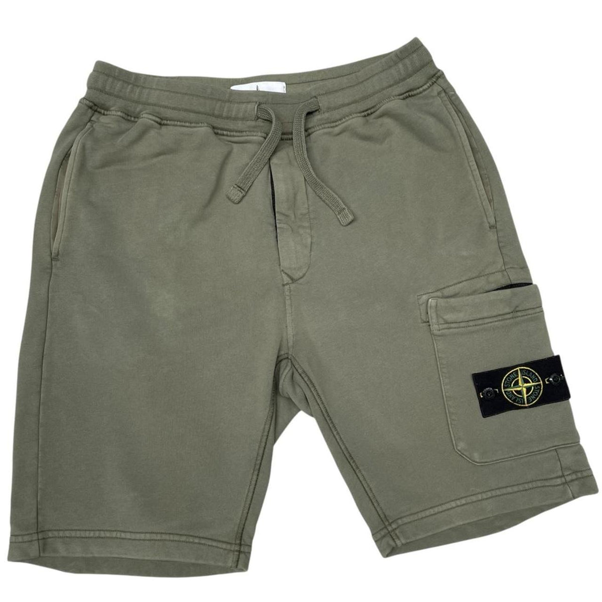 Stone Island green jogger shorts with logo patch and cotton material.
