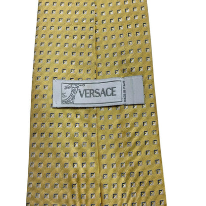 Versace yellow silk tie with subtle pattern and faint mark on front.