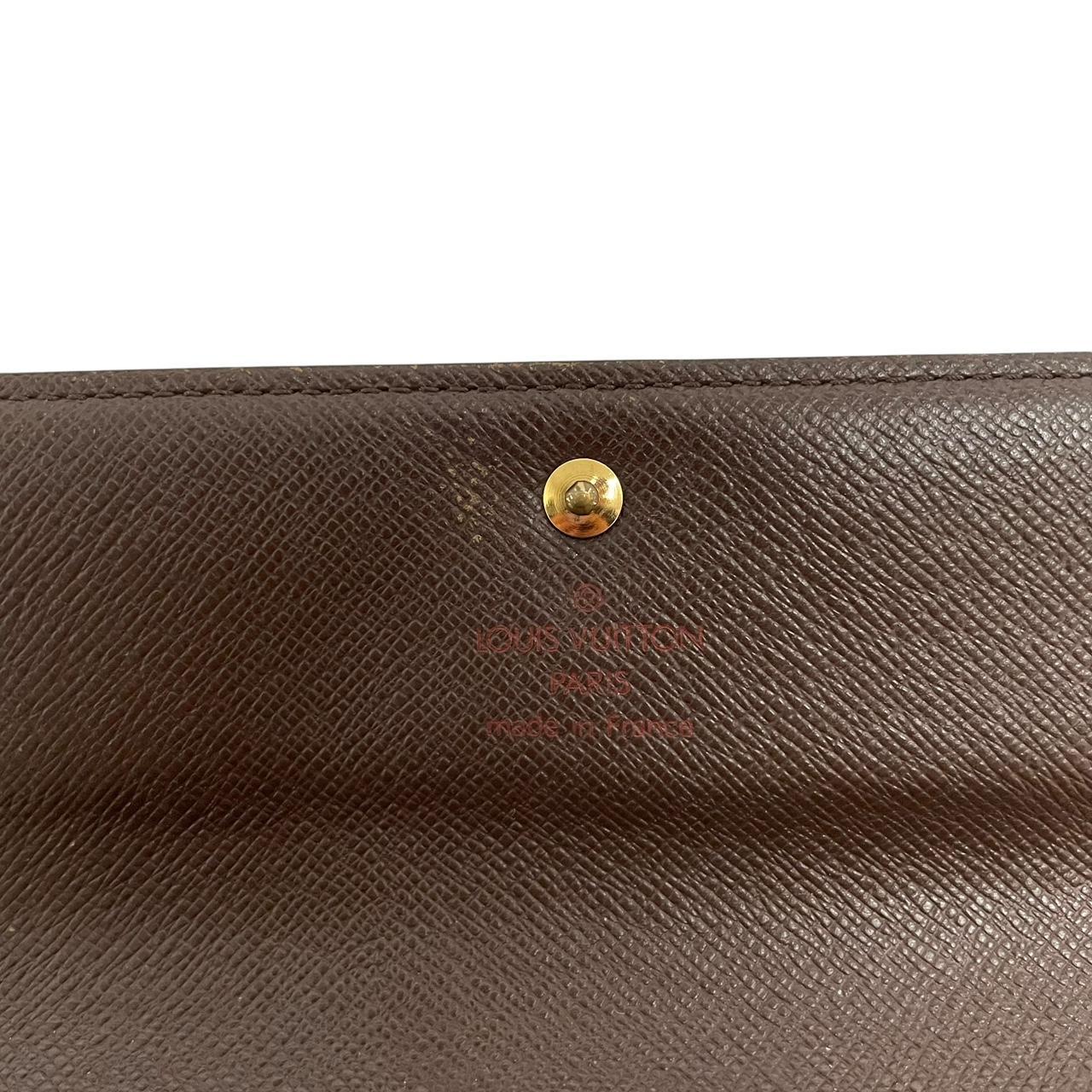 Louis Vuitton gold crossbody wallet Damier Ebene canvas with removable strap and logo.