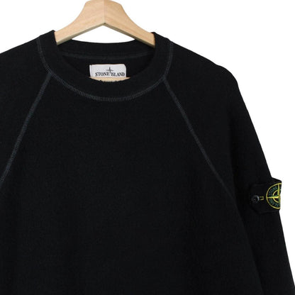 Stone Island black knit jumper with logo badge and cotton/nylon blend material.