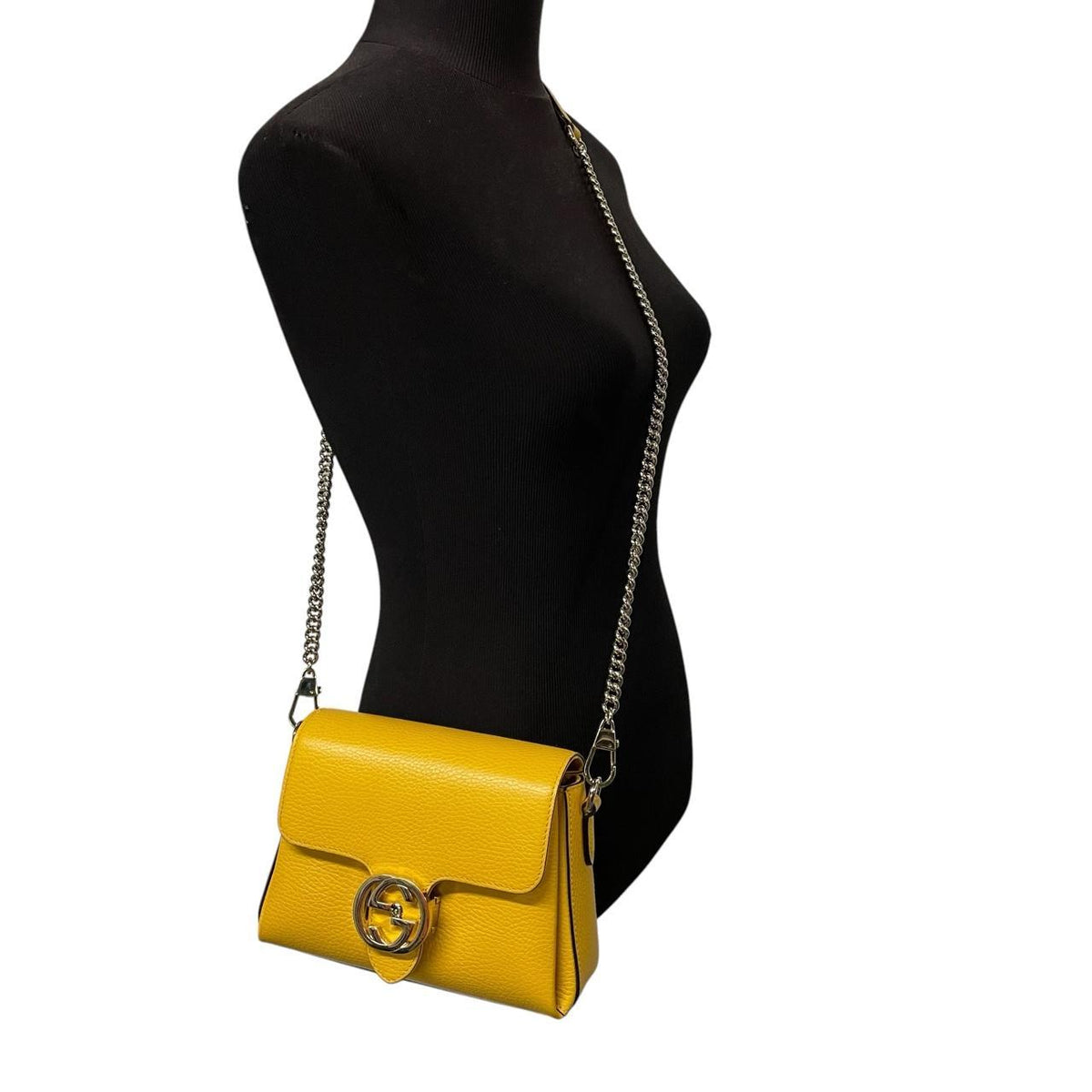 Gucci yellow leather crossbody bag with interlocking G logo and minor metal scratches.