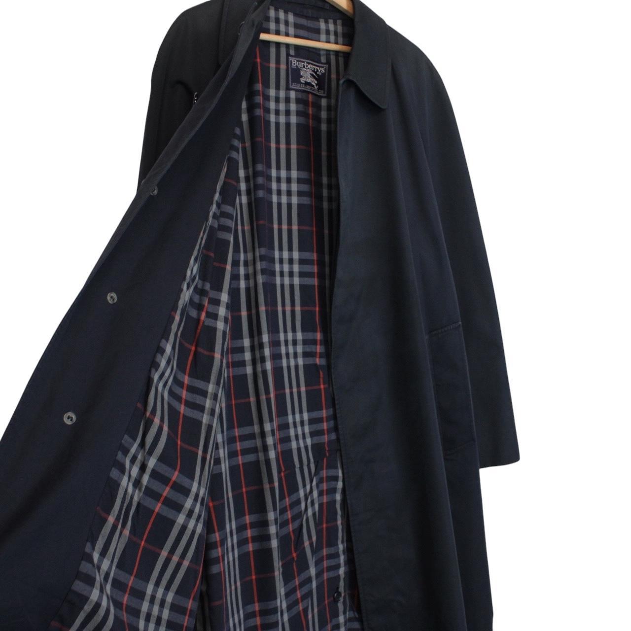 Burberry navy blue trench coat featuring classic Nova Check pattern and single-breasted design.