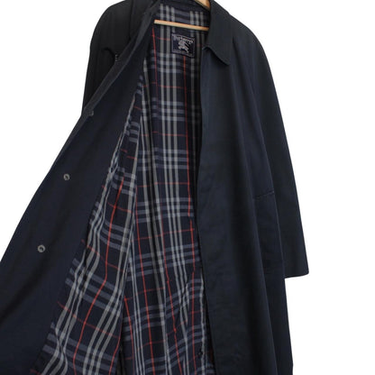Burberry navy blue trench coat featuring classic Nova Check pattern and single-breasted design.
