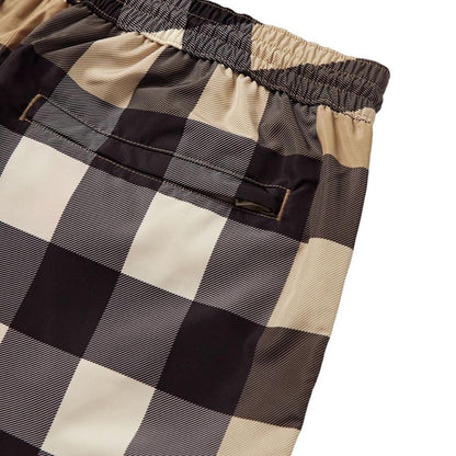Burberry beige swim shorts featuring Nova Check pattern and nylon material.