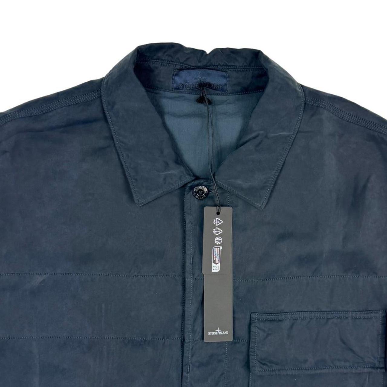 Stone Island navy blue overshirt jacket with flap pocket and monochrome logo patch.