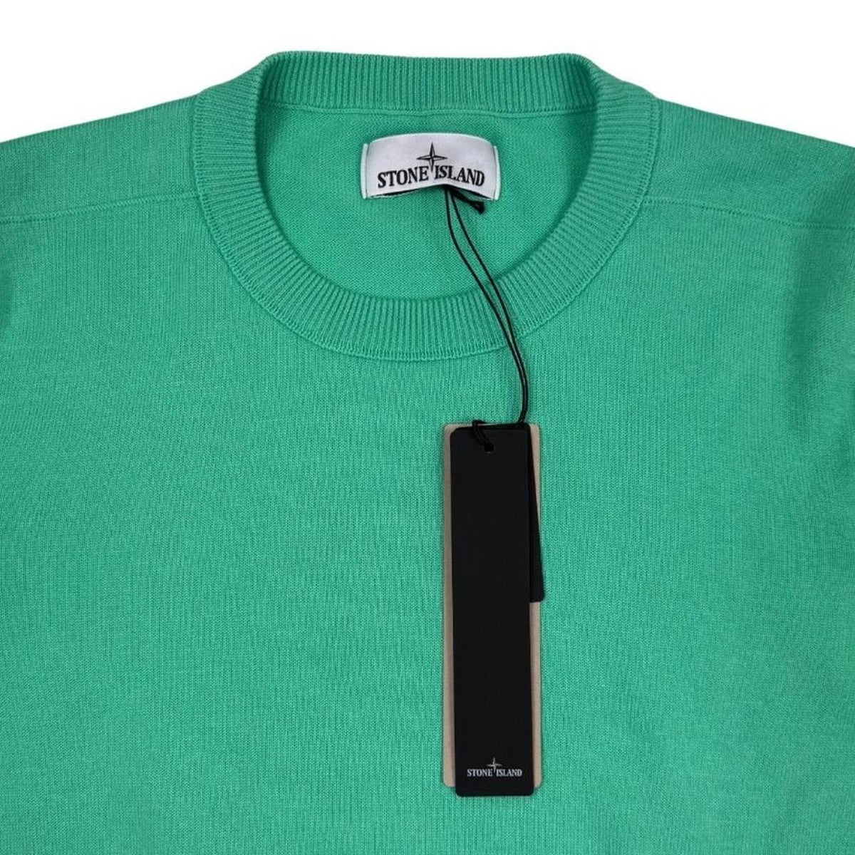 Stone Island green knit jumper made from organic cotton with logo patch detail.