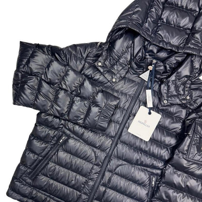 Moncler navy blue hooded puffer jacket with logo patch and nylon material.