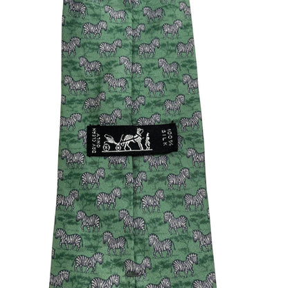 Hermes green silk tie featuring zebra print design and logo detail.