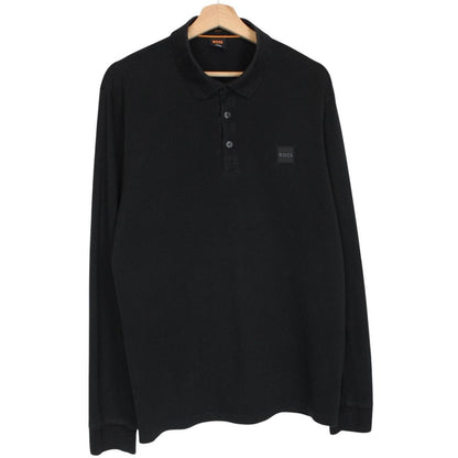 Hugo Boss black long sleeve polo shirt, slim fit, cotton material, subtle wear marks.