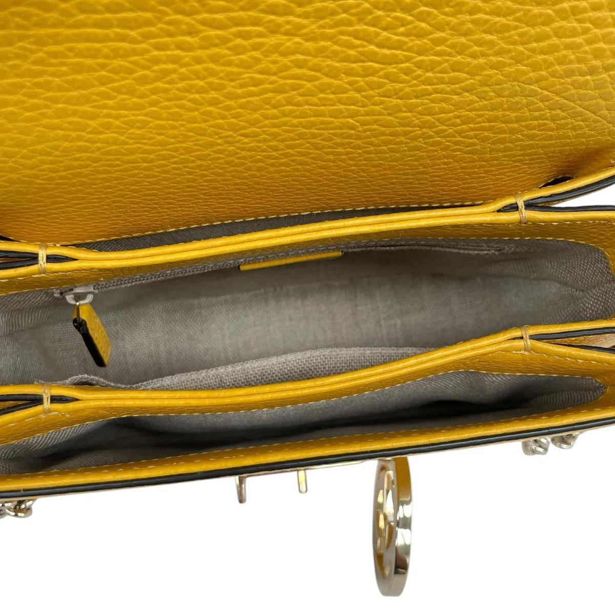 Gucci yellow leather crossbody bag with interlocking G logo and minor metal scratches.