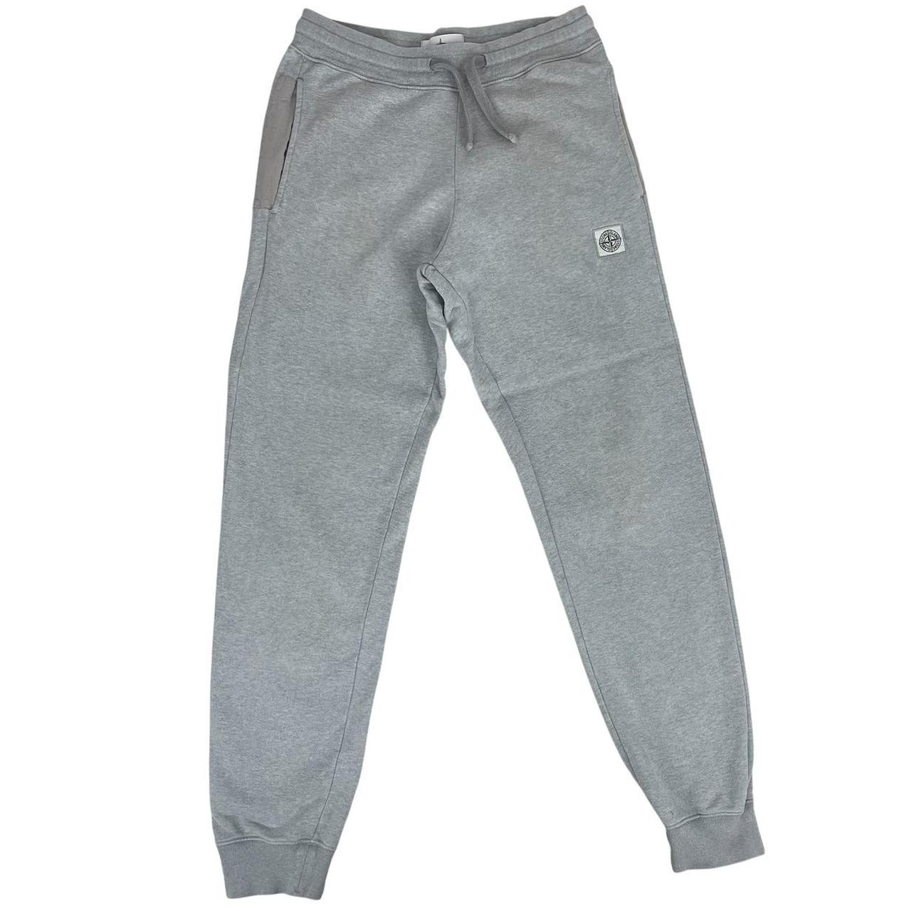 Stone Island grey tracksuit bottoms cotton material with logo patch and faint marks.
