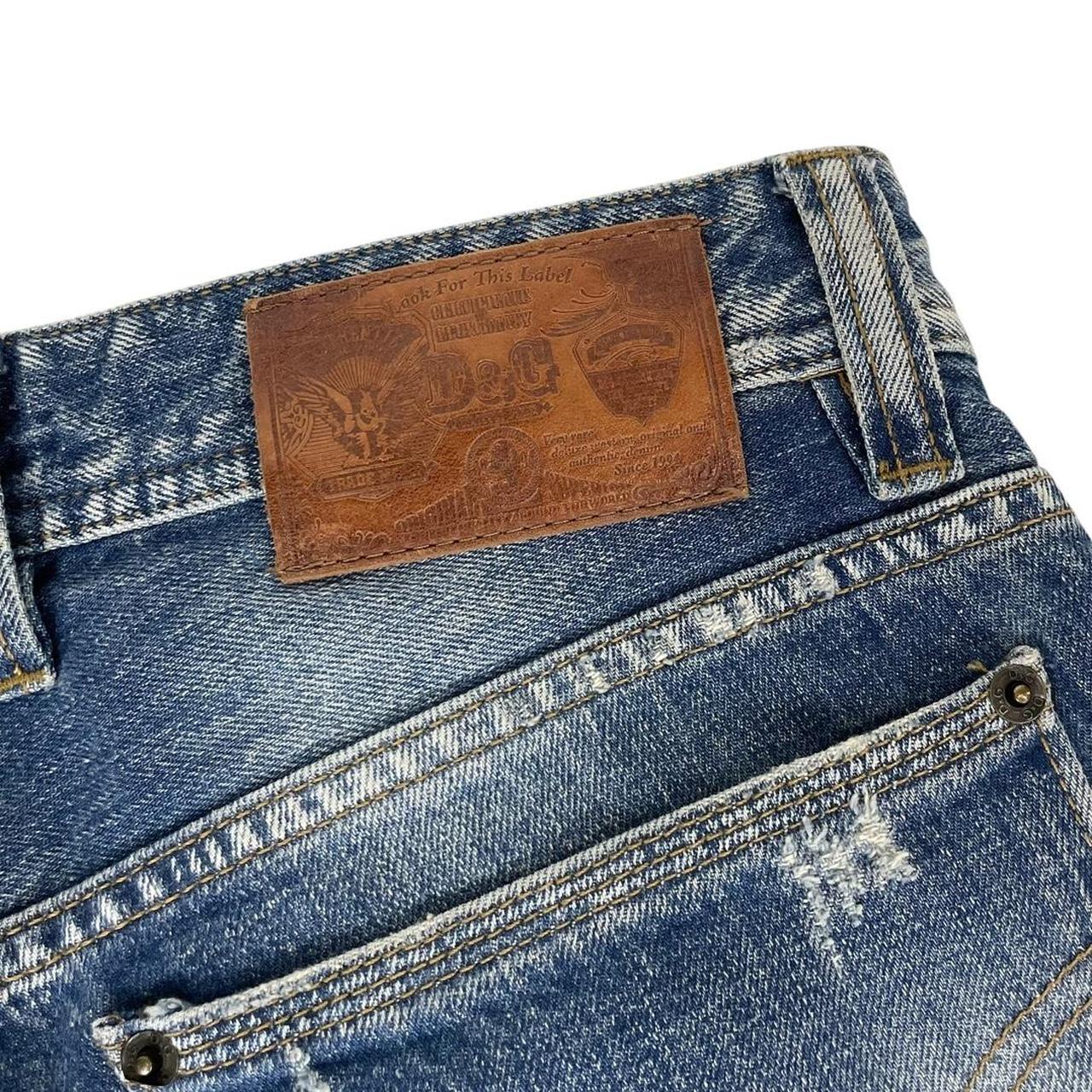 Dolce & Gabbana blue straight jeans mid wash with logo patch and slim fit design.