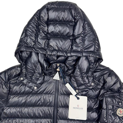 Moncler navy blue hooded puffer jacket with logo patch and nylon material.